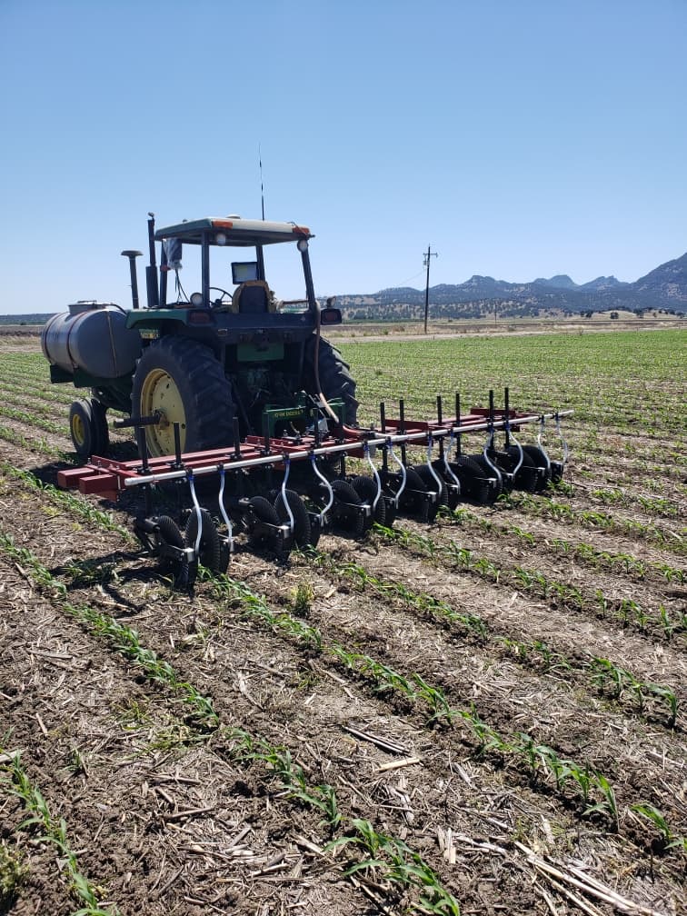 A sidedress applicator equipped with coulters cutting through field residue